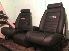 two black leather seats sitting next to each other