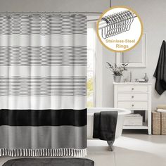 a bathroom with a bathtub, rug and shower curtain in black and white colors