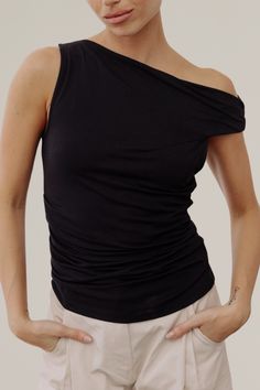 this asymmetrical twist shoulder top is a fitted top that is made from a soft, stretch modal-blend fabrication. it boasts an asymmetrical twist shoulder and ruching at the waist. can be worn off the shoulder for a more dramatic look. this is the perfect top to throw on with your favorite pair of jeans or skirt, paired with boots or sandals for an effortless look. Dramatic Look, Fitted Top, Dress Romper, Black Media, Sweater Jacket, Everyday Outfits