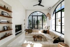 a living room filled with furniture and lots of windows