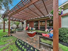 an outdoor patio with seating and pergolated area