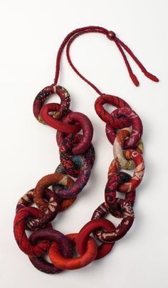 Silk Kantha Convertible Chain Necklace by Mieko Mintz . A chain necklace unlike any other! Exaggerated links are sewn from vintage silk saris and finished with kantha stitching. The silk cord adjusts to be worn long, as shown, or short, like a choker. Each is unique, and colors and patterns will vary. Limited quantities available. Fiber Art Jewelry, Silk Necklace, Diamond Cross Necklaces, Necklace Ideas, Fiber Jewelry, Fabric Necklace, Gold Bracelets, Creation Couture, Solitaire Necklaces