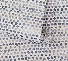 two sheets that have blue dots on them