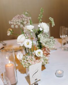 the table is set with flowers and candles