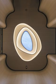 the inside of a building with a round window and circular light fixture on it's side