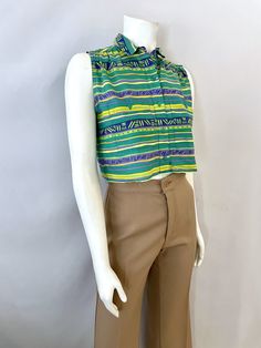 "Vintage Women's 90's Lizsport Petites, Sleeveless, Cropped Top (S) 4441 This Ladies top comes in cotton with a geometric and striped print in green, yellow and purple, is sleeveless with five front button closure and small peter pan collar. The top is light weight and does not stretch with a matte surface. 100% Cotton Made in Phillippeans *This top is in excellent condition. Size: (S) Modern Day 2/4 (Tag Size: Petite Small) Bust: 36\" Length: 16 1/2\" Shoulder to Shoulder: 13\" Weight: 5 oz Fol Retro Multicolor Cotton Vest, Retro Green Sleeveless Tank Top, Summer Striped Cotton Vest, Retro Multicolor Summer Vest, Multicolor Retro Summer Vest, Vintage Yellow Sleeveless Top, Retro Green Sleeveless Top, Retro Sleeveless Cotton Tops, Striped Sleeveless Cotton Top