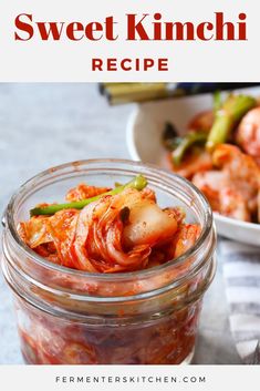 a glass jar filled with food next to another bowl full of vegetables and sauces