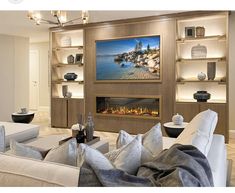 a living room filled with furniture and a flat screen tv mounted to the wall over a fire place