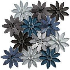 a bunch of flowers that are on top of each other in blue, grey and white