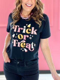 Get ready to bewitch the Halloween night with our "Trick or Treat" women's graphic tee! This spook-tacular shirt is the perfect blend of style and eerie charm, making you the ultimate treat-seeker this Halloween season. Whether you're out collecting candy or just looking frightfully fabulous, this tee is a bewitching choice that will cast a spell of fun wherever you go! True To Size Fabric- 100% Cotton Unisex fit Fun Halloween Graphic Print T-shirt, Fitted Halloween T-shirt With Character Print, Affordable Halloween Graphic Print T-shirt, Fall Witchy Graphic Print T-shirt, Halloween Multicolor Graphic Print T-shirt, Black Witchy Halloween T-shirt, Women Tees, Emma Lou, Halloween Novelty T-shirt With Graphic Print