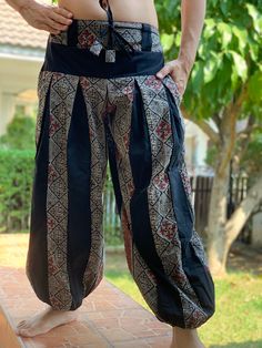 "These super soft rayon baggy unisex harem pants have the \"flow\", perfect of yoga or just a cool strolling. Comfort and character are what these pants are all about. They have the traditional sarong look & feel but a lot more practical when it comes to activity like yoga. As a bonus, they are convertible! Just pull them up and you get yourself a cute jumpsuit in a flash. Together with elastic cuff legs, you can wear them short or long. The pants have smock waist (wide bang elastic) with no Black Bohemian Harem Pants With Relaxed Fit, Black Bohemian Relaxed Fit Harem Pants, Black Cotton Hippie Harem Pants, Black Bohemian Yoga Pants For Festivals, Bohemian Black Yoga Pants For Festivals, Traditional Harem Pants For Meditation, Loose Fit Harem Pants For Yoga And Festivals, Black Cotton Harem Yoga Pants, Traditional Relaxed Fit Harem Pants For Yoga