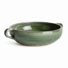 a green ceramic bowl with handles on a white background, the bowl is empty and ready to be used as a serving dish