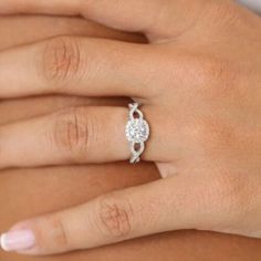 a woman's hand with a diamond ring on it