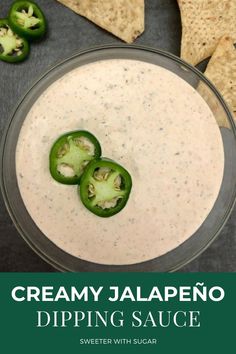 creamy jalapeno dip in a glass bowl with tortilla chips on the side