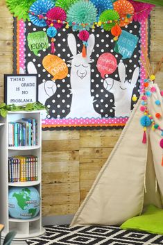 a child's teepee tent with decorations on the wall