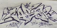 some graffiti writing on a piece of paper