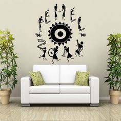 a living room with a white couch and black wall decal on it's side