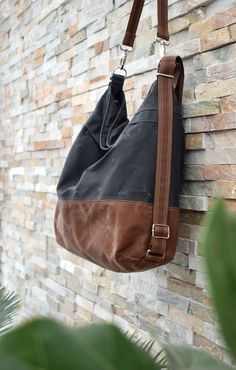 "The Convertible bag, with its versatile design, can be worn in different ways: * As a cross body or messenger * As a shoulder bag * As a backpack You decide the way to use it, depending on your needs. Changing from one to another is as easy as adapting the length of the straps. The Convertible bag is made from a waxed cotton canvas, combining grey canvas with a brown bottom. This makes your bag water resistant and very durable. The waxed canvas will age beautifully over time. The bag closes wit Brown Canvas Hobo Bag With Canvas Lining, Brown Hobo Bag With Canvas Lining For Everyday Use, Brown Coated Canvas Hobo Bag For Travel, Brown Canvas Hobo Bag With Leather Handles, Travel Brown Coated Canvas Hobo Bag, Modern Brown Canvas Hobo Bag, Brown Coated Canvas Bag With Adjustable Strap, Brown Canvas Hobo Bag With Adjustable Strap, Brown Canvas Hobo Bag For On-the-go