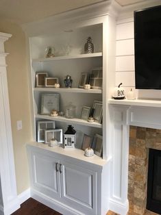 a living room filled with furniture and a flat screen tv on top of a fireplace