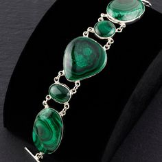 Inspired by the natural beauty and healing properties of malachite, this bracelet combines the vibrant energy of the gemstone with the timeless elegance of sterling silver. Adorned with multiple genuine malachite stones, each showcasing the stone's unique, vibrant green patterns. Ideal for those who love bold and eye-catching jewelry. Gemstone - Genuine Malachite 925 Sterling silver Adjustable from 7" to 8.5" L  Handmade in Taxco, Mexico Spiritual Malachite Bracelet Jewelry, Malachite Bracelets With Natural Stones, Malachite Gemstone Bracelet, Green Sterling Silver Bracelet With Natural Stones, Green Sterling Silver Bracelet With Polished Finish, Green Sterling Silver Bracelets With Polished Finish, Elegant Handmade Malachite Bracelets, Elegant Malachite Bracelet Jewelry, Elegant Malachite Bracelet