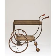 an old fashioned wooden and metal cart with wheels