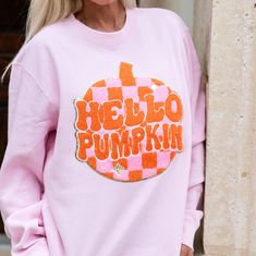 Get cozy this fall with our Hello Pumpkin Pink and Orange Sweatshirt. Made from soft, light pink fabric and featuring a playful orange and pink chenille patch sewn onto the shirt, the Hello Pumpkin Pink and Orange Sweatshirt is perfect for lounging or going out! With gold glitter accents, the Hello Pumpkin Pink and Orange Sweatshirt adds a pop of fun to your outfit. Independent Brand men's/unisex style. Trendy Pink Fall Sweatshirt, Trendy Pink Sweatshirt For Fall, Pink Sweatshirt For Fall Loungewear, Pink Crew Neck Sweatshirt For Fall, Casual Pink Sweatshirt For Fall, Cute Pink Fall Sweatshirt, Pink Fall Loungewear Tops, Fall Pink Loungewear Tops, Long Sleeve Sweatshirt With Patches For Fall