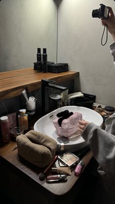 a woman taking a photo of her hair in front of a mirror with a camera