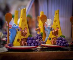 three plates with cheese and figurines on them, each decorated like a mouse