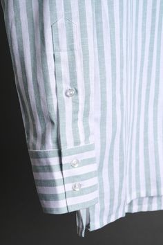 A bespoke shirt crafted from a textured cotton blend fabric in an oversized candy stripe. The larger striped pattern gives it a punch of style, making it a great casual shirt that can be worn with chinos or jeans - or under suits and jackets. The lightweight fabric drapes effortlessly, making it an ideal choice for those seeking a sophisticated yet relaxed look. Cotton Button-up Tops With Horizontal Stripes, Striped Cotton Top With Shirttail Hem, Cotton Tops With Vertical Stripes For Daywear, Pinstripe Cotton Top With Spread Collar, Striped Cotton Top With Spread Collar, Yarn-dyed Striped Collared Shirt, Pinstripe Cotton Shirt With Spread Collar, Cotton Button-up Top With Contrast Stripes, Cotton Shirt With Vertical Stripes For Daywear