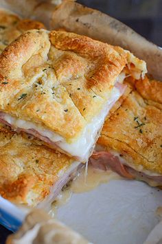 a close up of a sandwich in a pan with melted cheese and ham on it