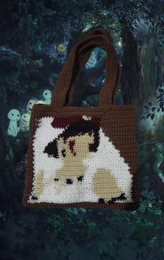 a cross stitch bag with a dog on it