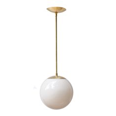 a white and gold ball hanging from a ceiling light with a golden metal rod in the middle