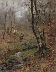 two people walking in the woods by a stream