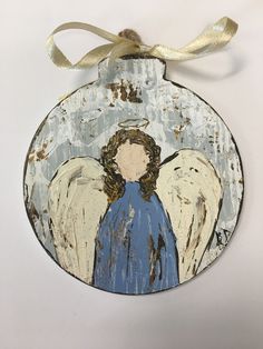 an angel ornament hanging on a white wall