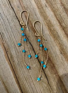 "14k Solid Gold Blue Apatite Gemstone Dangle Earrings. These are lightweight long dangle chain earrings that have a lovely pop of turquoise blue color from the apatite gemstones that catch the eye when worn.  They are a fun, playful, colorful earring great to wear in Spring or Summer. The chain is a 1.3mm 14k solid gold cable chain with seven 3mm faceted blue apatite gemstones spaced intermittently down the three strands of chain.  They measure 2.75\" long.  All designs purchased come in a box r Blue 14k Gold-filled Dangle Jewelry, 14k Gold Blue Dangle Earrings, Blue 14k Gold Dangle Earrings, Blue 14k Gold Dangle Jewelry, Blue 14k Gold-filled Dangle Earrings, Blue 14k Gold Filled Dangle Earrings, Gemstone Chip Necklace, Turquoise Jewelry Earrings, Blue Gemstone Earrings