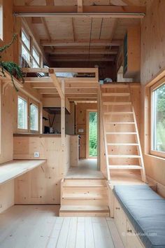 the interior of a tiny cabin with stairs and windows