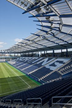 an empty soccer stadium with blue seats