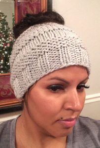 a woman is taking a selfie in front of a mirror wearing a knitted headband