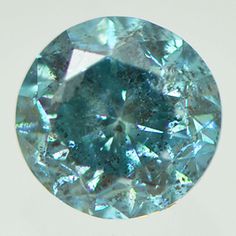 an aqua green diamond is shown in this close up photo, with the center stone visible