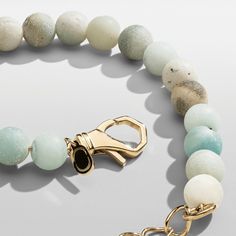 Hand-strung with a blend of ocean-coloured beads, this statement bracelet is one-of-a-kind. Made exclusively from real stone, each bead has a unique matte finish and natural veining, ensuring no two pieces are alike. Its 18 karat gold accents make it perfect for wearing solo or pairing with your favourite gold pieces, while its adjustable-length lobster clasp guarantees a perfect fit around the wrist. One Size: Adjustable (18-22cm) Peace of Mind: Lifetime Warranty Included Luxury Beaded Bracelets With Natural Stones, Amazonite Beaded Bracelets With Natural Stones, Amazonite Natural Stones Beaded Bracelet, Elegant Amazonite Beaded Bracelets, Amazonite Gemstone Beaded Bracelets, Amazonite Bracelets With Natural Stones, Marble Jewelry With Natural Stones In Round Beads, Elegant Amazonite Bracelet For Healing, Marble Color Jewelry With Round Natural Stone Beads