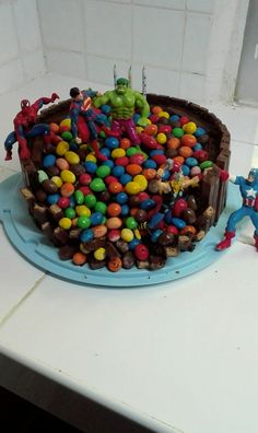 there is a cake decorated with candy and characters