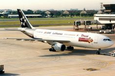 an airplane that is sitting on the tarmac at an airport with luggage carts around it