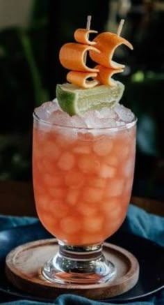 a drink with orange and lime garnish on top