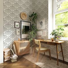 a room with a table, mirror and plant in the corner on the wall next to it