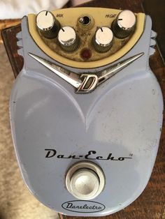 an electric guitar pedal sitting on top of a wooden table