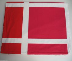 a red and white flag is laying on the table