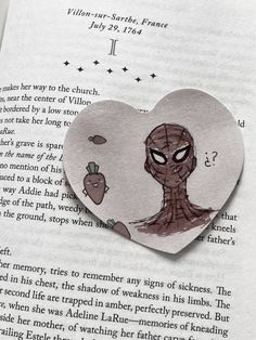 a heart shaped brooch with an image of a spiderman holding a carrot in it