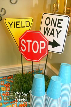 two stop signs are next to each other in front of blue cups and vases