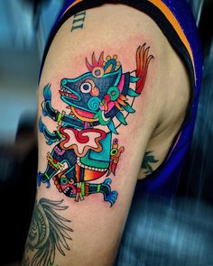 a colorful tattoo on the arm of a person