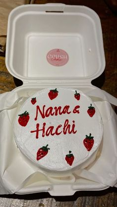 a cake in a white box with strawberries on the inside and writing nanna's hachii